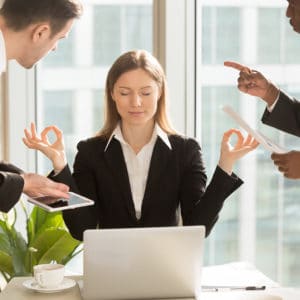 Balance - Woman meditating through work stress